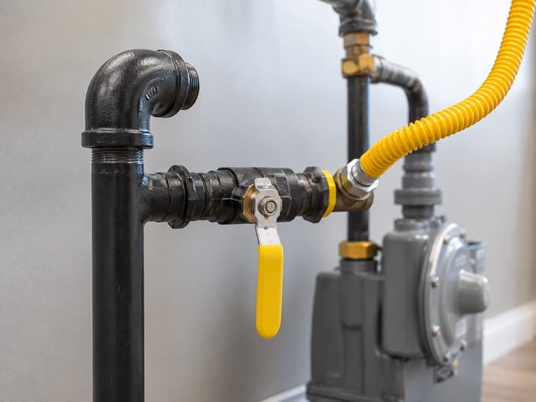 A black iron gas line being fitted and pressure tested.