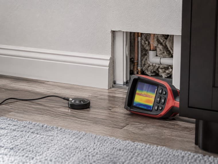 Acoustic leak detection equipment being used to locate a hidden leak.